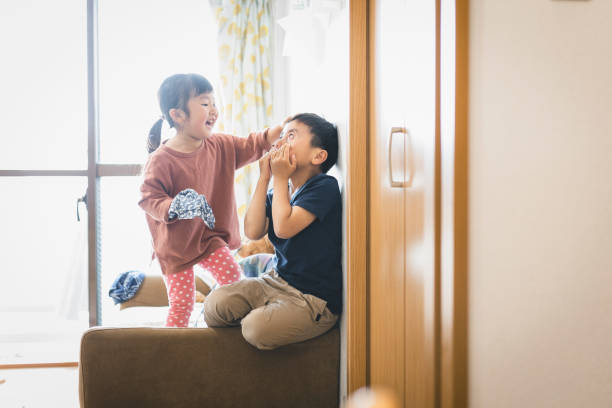 istock Siblings playing in the living room 1221183387