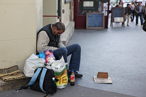 Paris - May 4 : A homeless man sitting on the street and asking for help, May 4, 2013 in Paris, France. Today, France has 130,000 homeless, and every day one of them dies