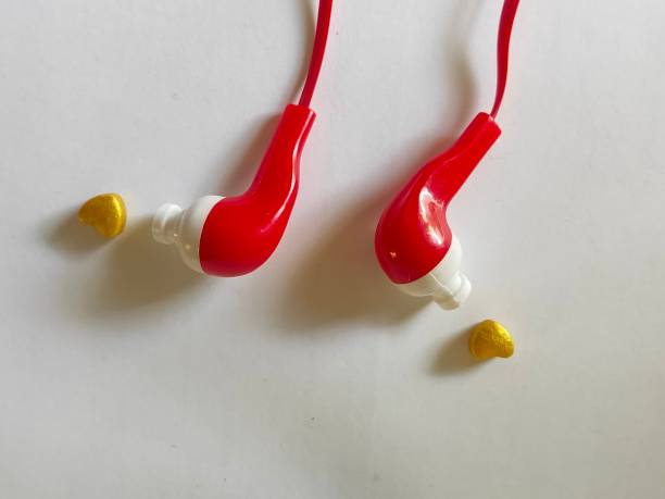 istock Red headphones on white background. Microphone on plain background. Listen to heart through earphone. Golden heart and a earphone. 1221185458
