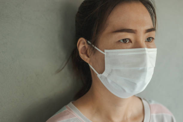 istock Asian woman wearing protective hygiene mask 1221185542