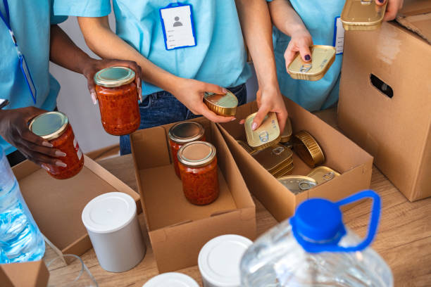 istock Cardboard boxes being filled with food donations. 1221186512