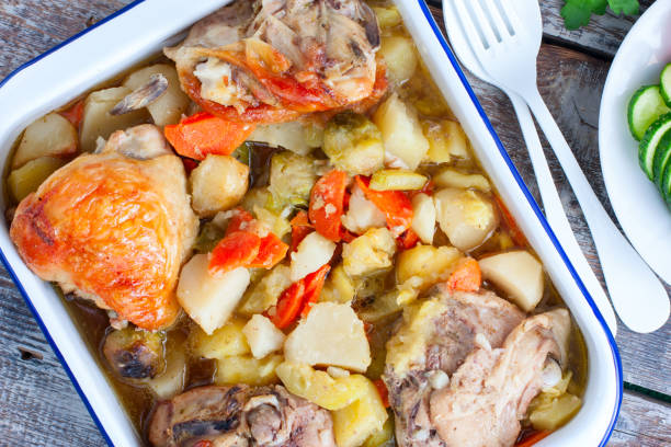 istock Baked chicken thighs with brussels sprouts, potatoes, carrots, onions, selective focus 1221186824
