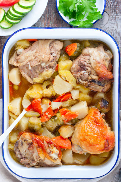 istock Baked chicken thighs with brussels sprouts, potatoes, carrots, onions, selective focus 1221186864