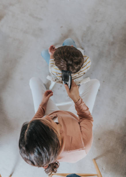 istock Boy getting a haircut during quarantine for COVID-19 1221186914