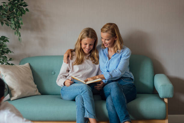 istock Mother Reading a Book with Her Daughter 1221186968