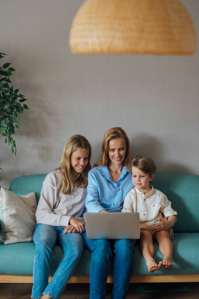 istock Mother and Children Looking at Laptop 1221186973