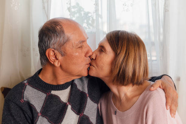 istock Senior couple kissing lips 1221188059