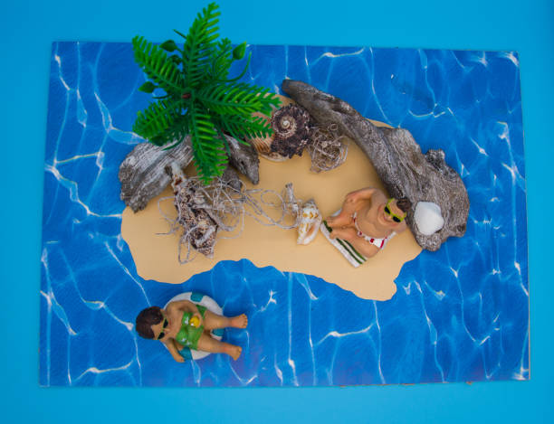 istock Funny holiday scene: plastic puppet marriage couple on lonely island 1221188064