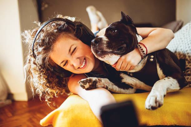 istock Woman playing with her dogs 1221189526