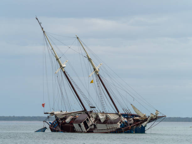 Grounded two-masted old sailing ship off Maria la Gorda Cloudy sky in the background, ship is afloat but listing to one side maria la gorda stock pictures, royalty-free photos & images