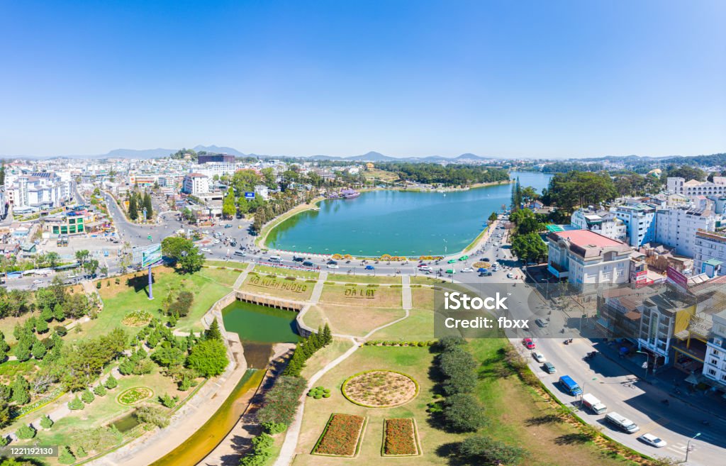 Aerial view of Da Lat city beautiful tourism destination in central highlands Vietnam. Clear blue sky. Urban development texture, green parks and city lake. Dalat Stock Photo