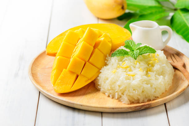 istock Ripe mango and sticky rice with coconut milk on white wood 1221195507