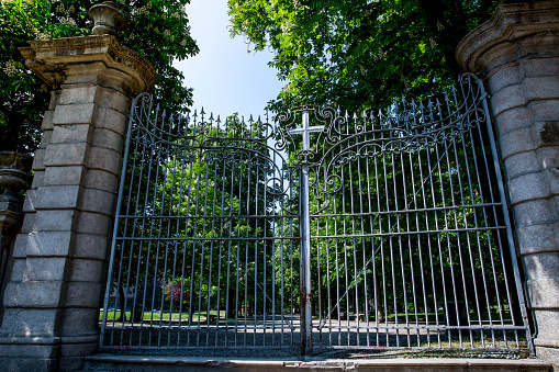 Public garden gate closed due to covid-19 virus. Lockdown in european town. Strange spring in Milan Italy. Report from the deserted cities, people are locked up. Nobody can go out streets are deserted
