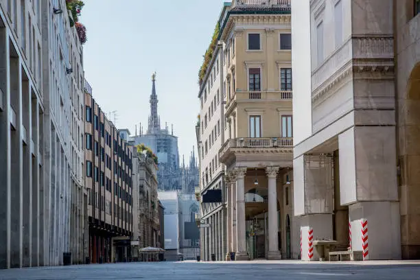 Photo of Empty streets due to covid-19 virus. Lockdown in european town. Strange spring in Milan corso Vittorio Emanuele Italy. Report from the deserted cities, people are locked up. Nobody can go out