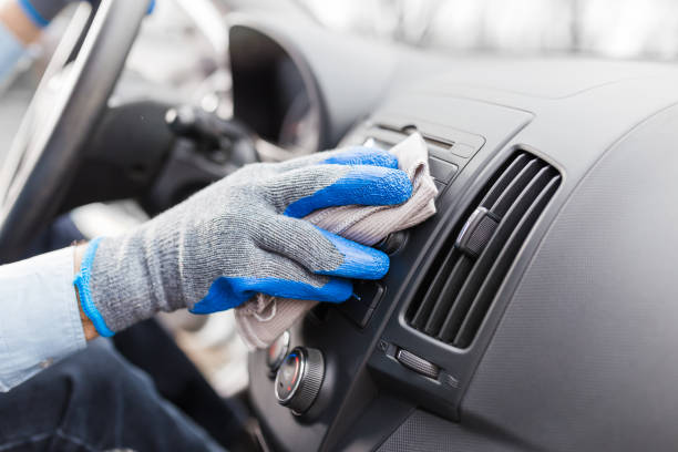 istock Auto service staff hand cleaning car interior with microfiber cloth. Car detailing and valeting concept 1221196960