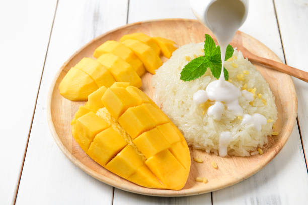 istock Coconut milk on sticky rice with Ripe mango on white wood 1221197006