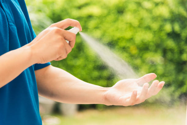 istock delivery express courier young man use spray sterilize before giving boxes to woman customer receiving 1221197270