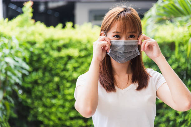 istock woman wearing face mask protective outdoor 1221197285
