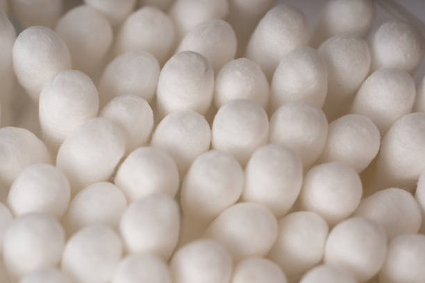istock Cotton swabs for cleaning ears as background texture pattern. Soft and abstract background created by arranging uniformly heads of cotton buds uniformly 1221197988