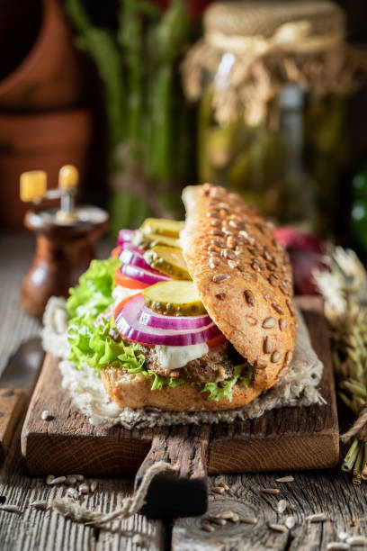 istock Sandwich with roasted pork neck, gherkins and red onion 1221199136