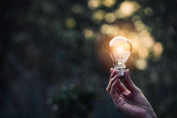 istock Innovation and energy concept of hand hold a light bulb and copy space for insert text. 1221200927