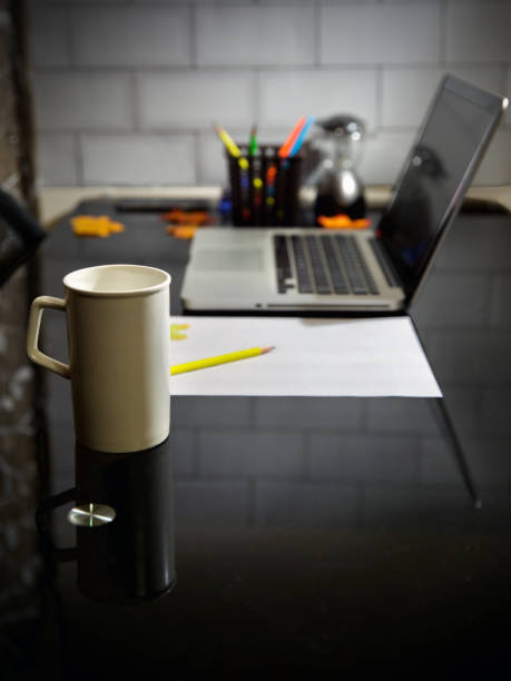 Coffee mug and laptop in office table. Copy Space in Background.