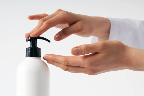 istock Woman hands pushing pump plastic soap bottle with copy space, using wash hand sanitizer gel pump dispenser. killing germs, bacteria and virus 1221201284