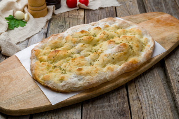 istock Focaccia with rosemary on wooden table 1221202267