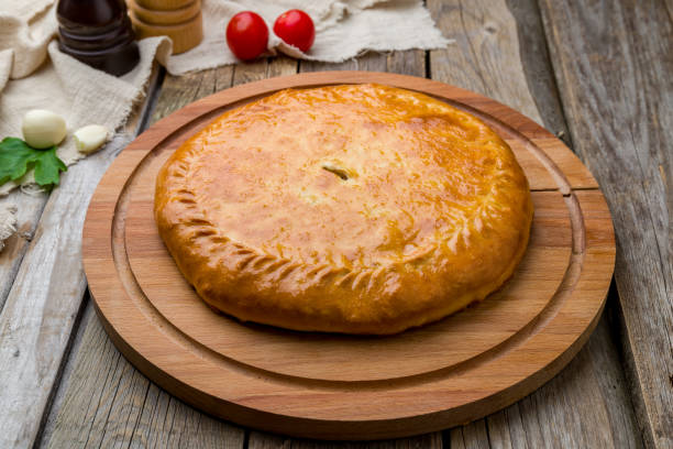 istock Ossetian pie with meat on wooden table 1221202338