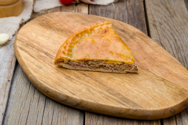 istock Ossetian pie with meat and potatoes on wooden table 1221202341