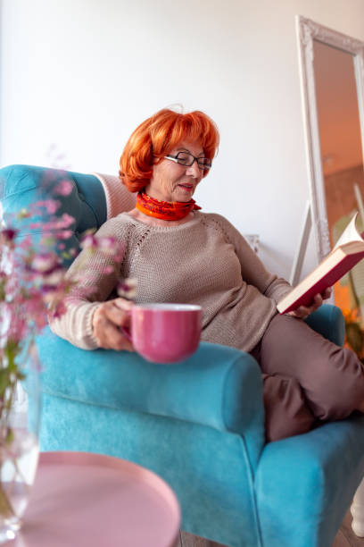 istock Senior woman reading a book 1221202465