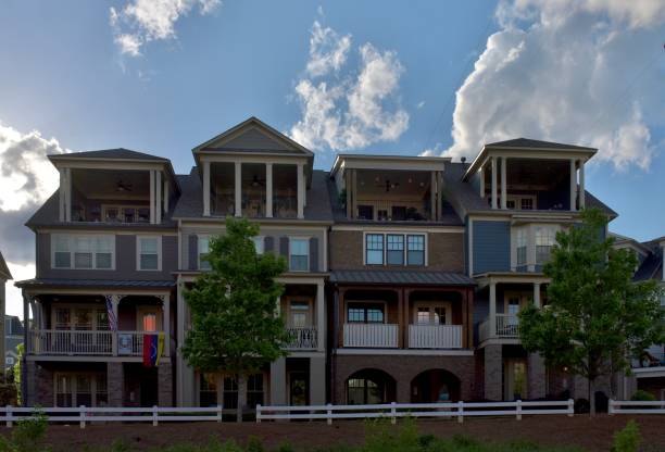 istock Row houses with a blue sky and clouds 1221202529
