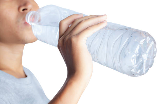 istock portrait of a young man drinking water isolated on white background. 1221203049