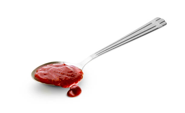 istock Red barbecue sauce in spoon isolated on white background 1221203213