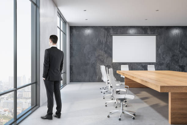 istock Businessman standing in meeting room 1221203300