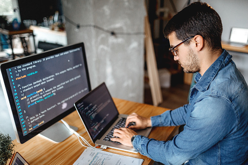 Male programmer working at home in his home office