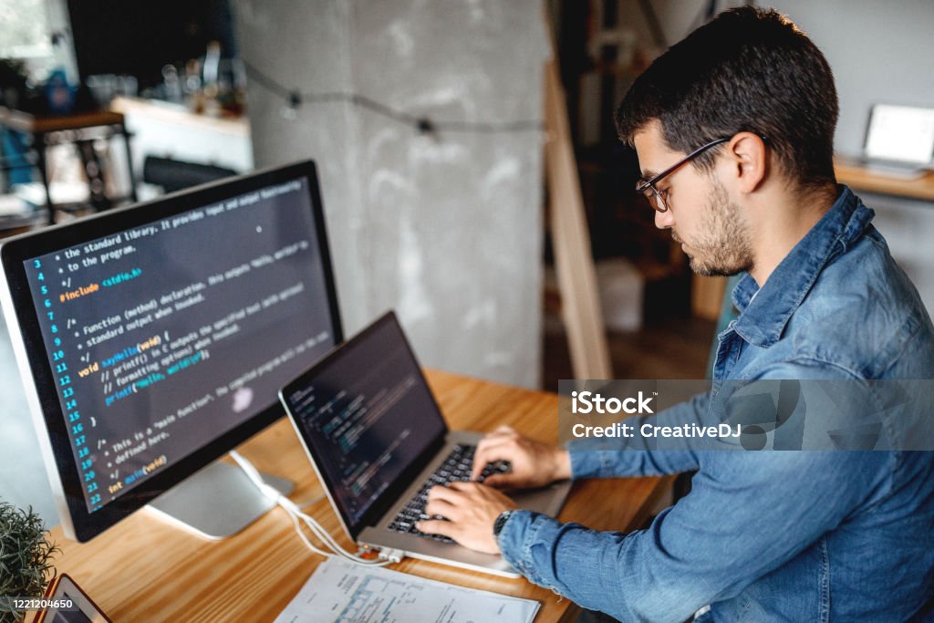 Business can not wait Male programmer working at home in his home office Artificial Intelligence Stock Photo