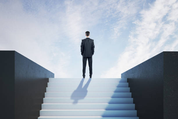 istock Businessman on ladder celebrating success 1221204814