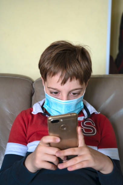 istock Boy with mask at home 1221205780