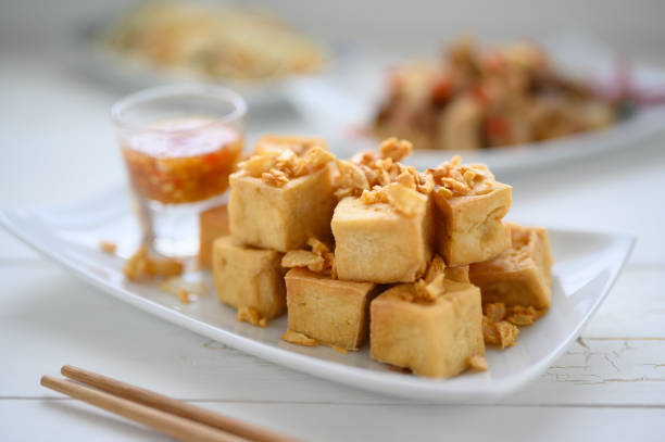 istock Deep fried tofu is cut into square balls on plate 1221206345