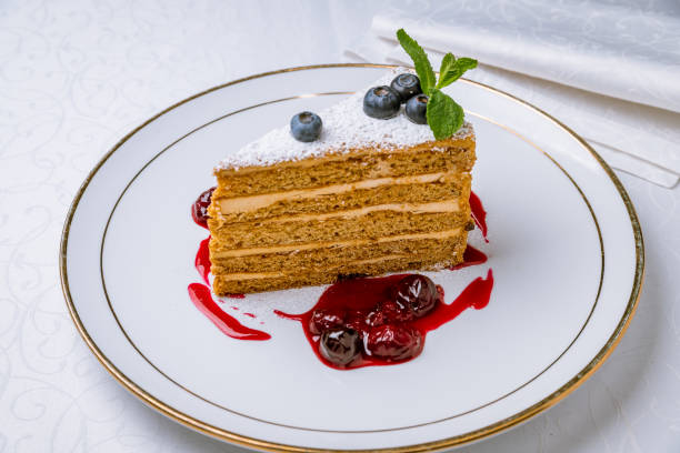 istock a piece of honey cake on white table 1221206352
