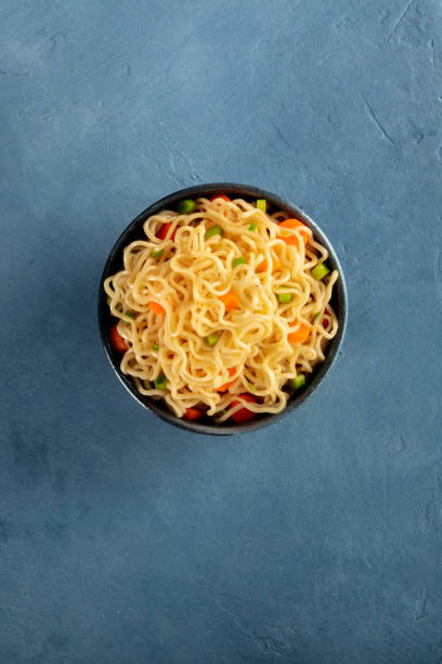 istock Instant noodles with carrot and scallions, overhead shot with copyspace 1221209335