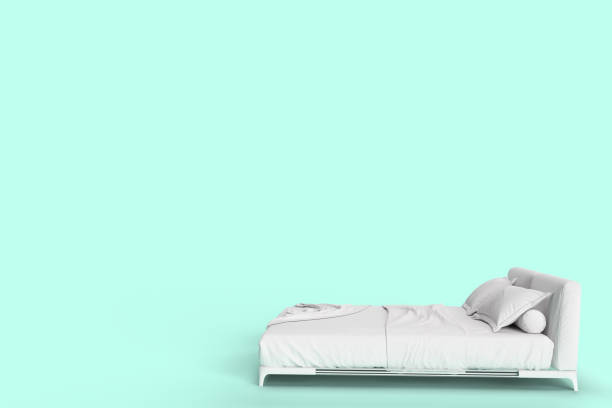 istock 3d render side view of white bed with white pillow cover and white bed sheet and blanket for mockup with a pastel cyan background. 1221209471