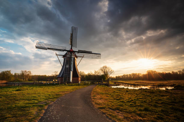 istock sunrise behind beautiful windmill, Holland 1221210795