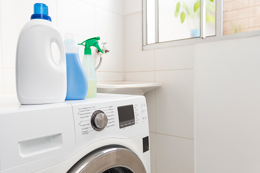 Washing machine with cleaning products. Cleaning concept.