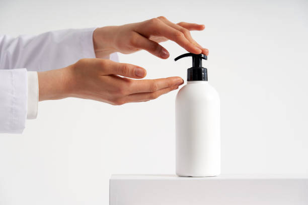 istock Woman hands pushing pump plastic soap bottle with copy space, using wash hand sanitizer gel pump dispenser. killing germs, bacteria and virus 1221214711
