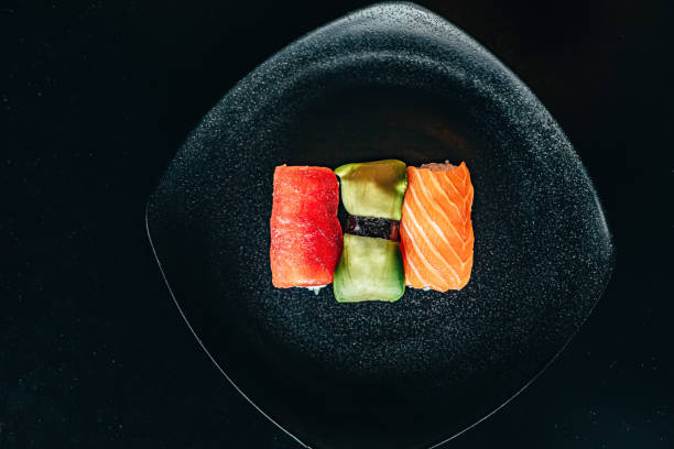 istock sushi of three kinds on a black plate. black table. horizontal orientation 1221216205