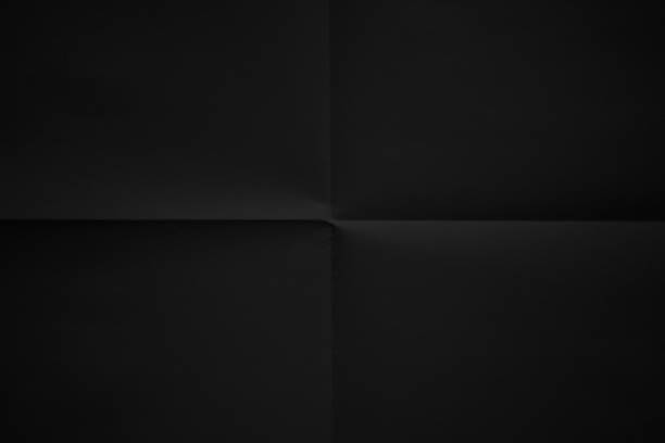 Black paper folded in four fraction background