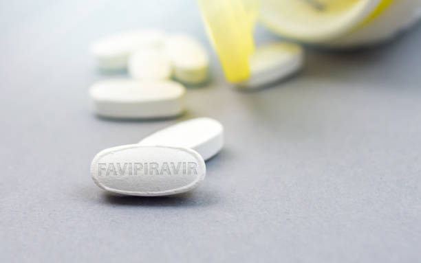 Favipiravir pill, possible treatment for Corona virus Sars CoV 2 Favipiravir pill, possible treatment for Corona virus Covid-19 food and drug administration photos stock pictures, royalty-free photos & images