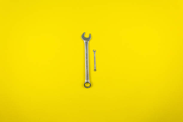 istock Set of wrenches of different sizes on a yellow background 1221218321